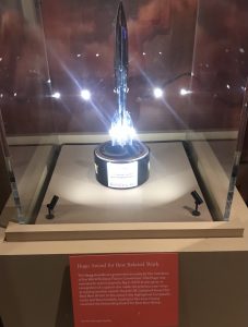 A Hugo award figure in an illuminated glass case with explanatory text.
