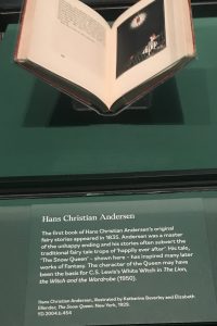 A book in a display case with a text description