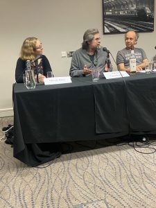 Three Panelists at a table covered in a black cloth